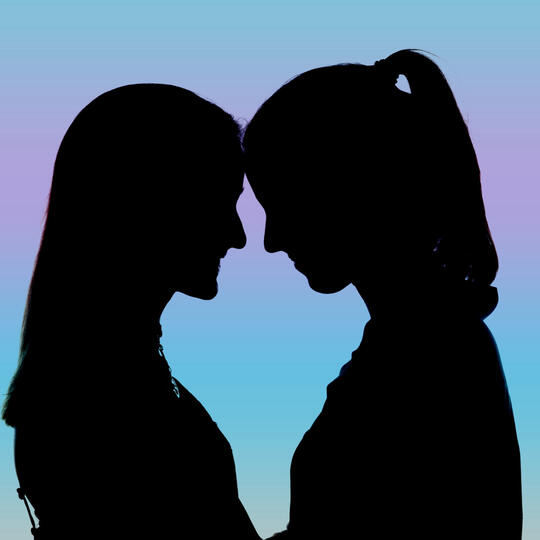 Two women touching foreheads